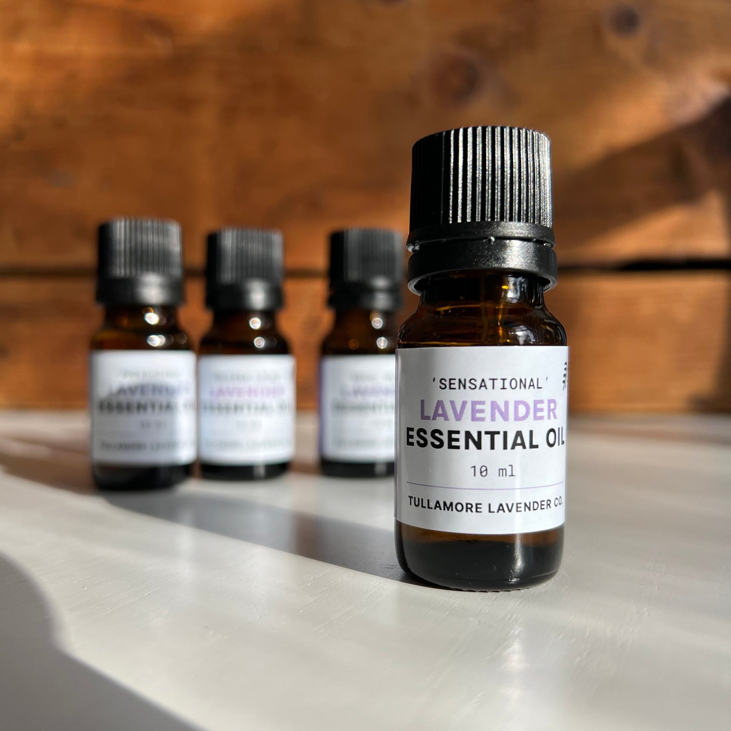 Amber bottle with black cap and label that says "Sensational Lavender Essential Oil"