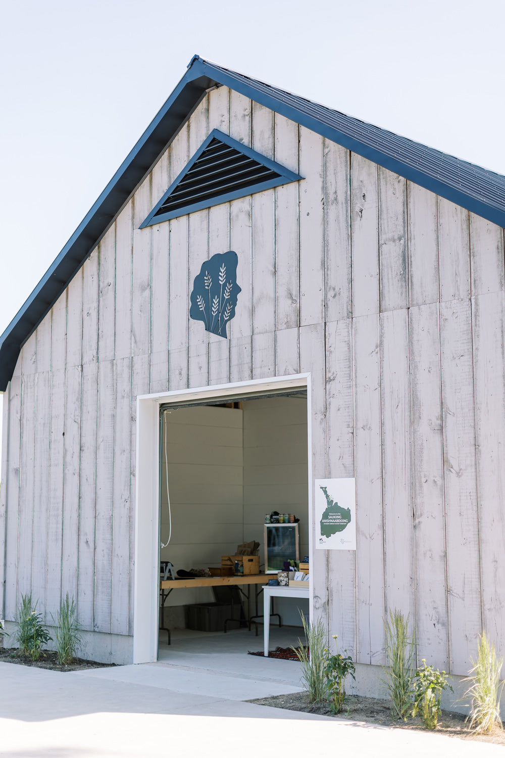 Grey wooden shed with large front door open. Tullamore Lavender logo in black on the front of the shed.