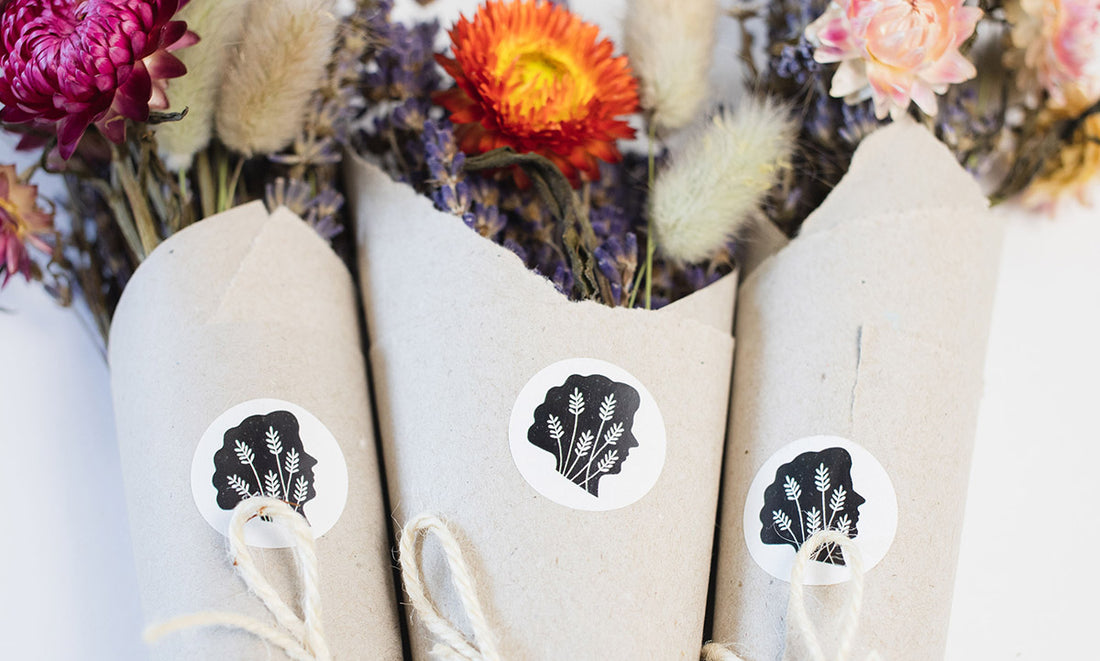 Close up shot of TLC logo stickers on wrapped dried bouquets
