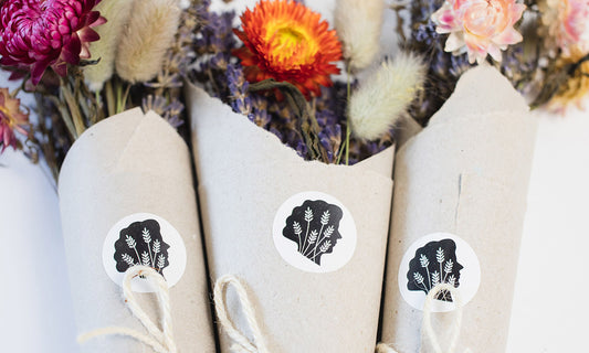 Close up shot of TLC logo stickers on wrapped dried bouquets