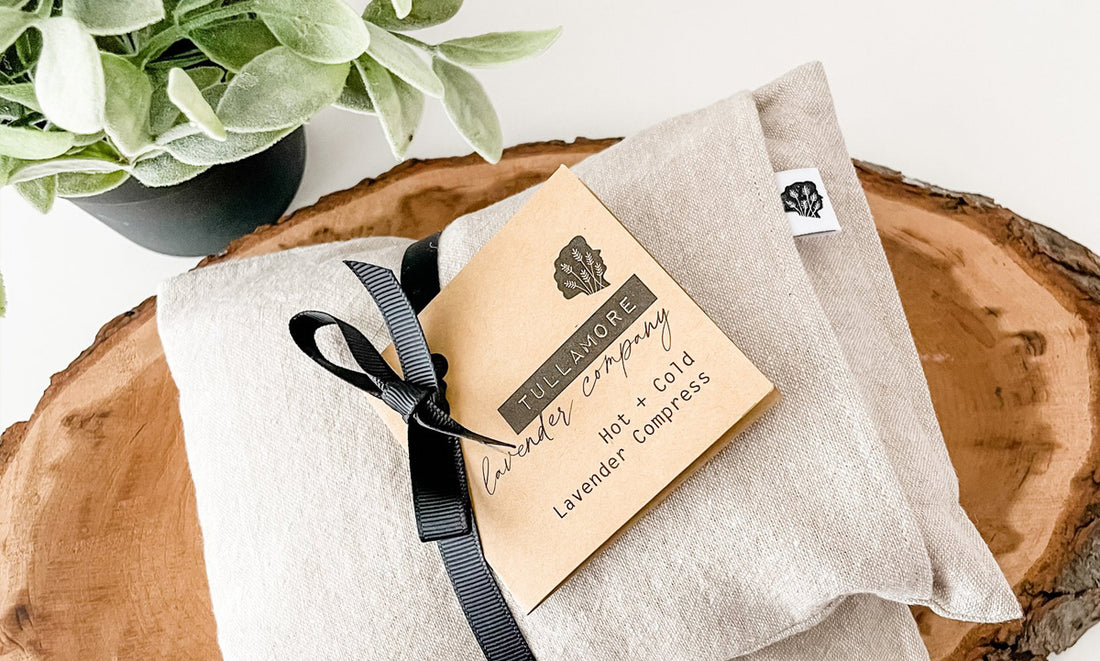 Tan linen compress with ribbon and tag on a wood board