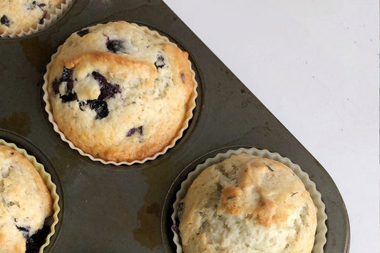 Golden brown blueberry muffins in tin