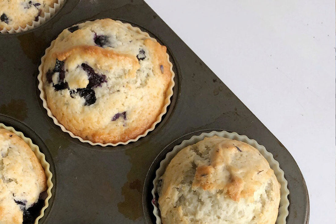 Golden brown blueberry muffins in tin