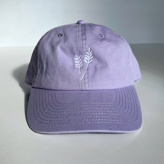 Purple cap with a white lavender design on a light gray background