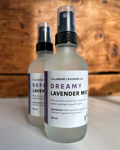 Two frosted glass spray bottles with white label that says "Lavender Mist"