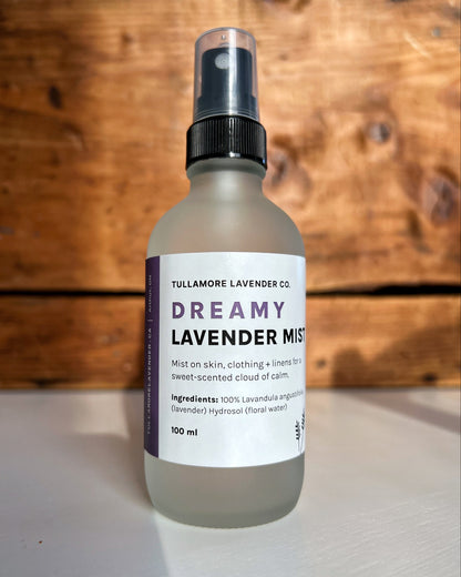 Frosted glass spray bottle with white label that says "Dreamy Lavender Mist"