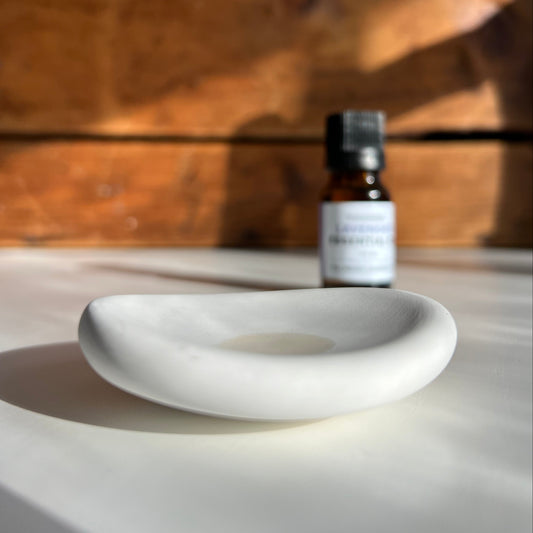 White rounded clay bowl with oil in center