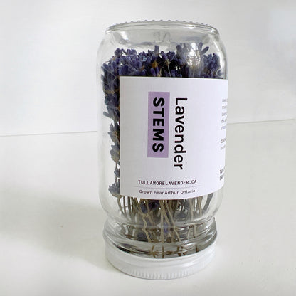 Small glass jar with white label on it that says "Lavender STEMS"
