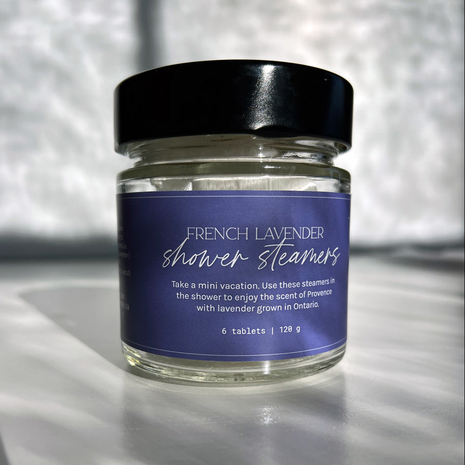 Jar of French Lavender shower steamers with a purple label on a light background