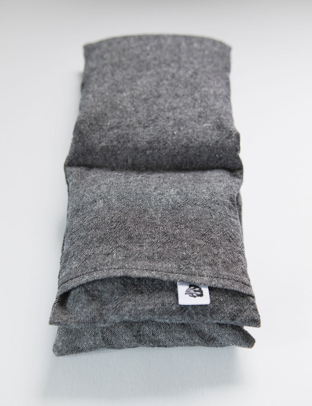 Charcoal linen wrap folded on white with TLC tag