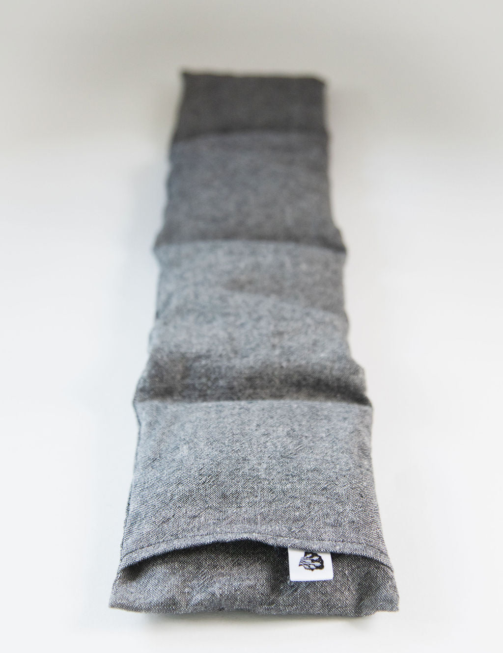 Charcoal linen wrap on white showing four sewn sections