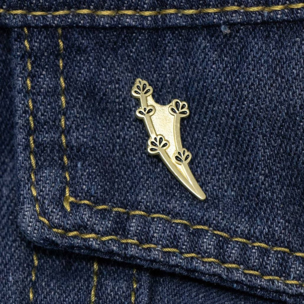 Gold lavender stem pin on dark jean fabric