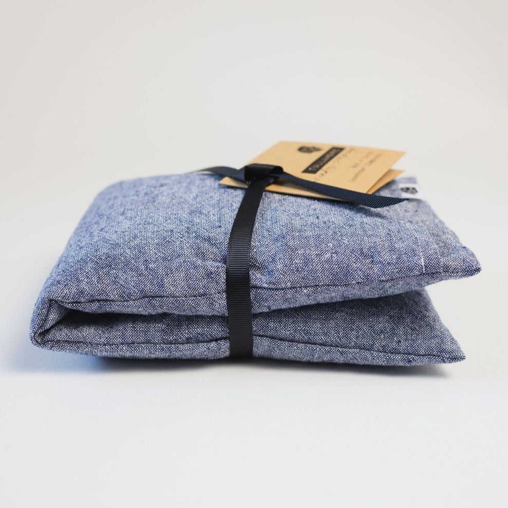 Blue linen compress folded with black linen and brown paper tag