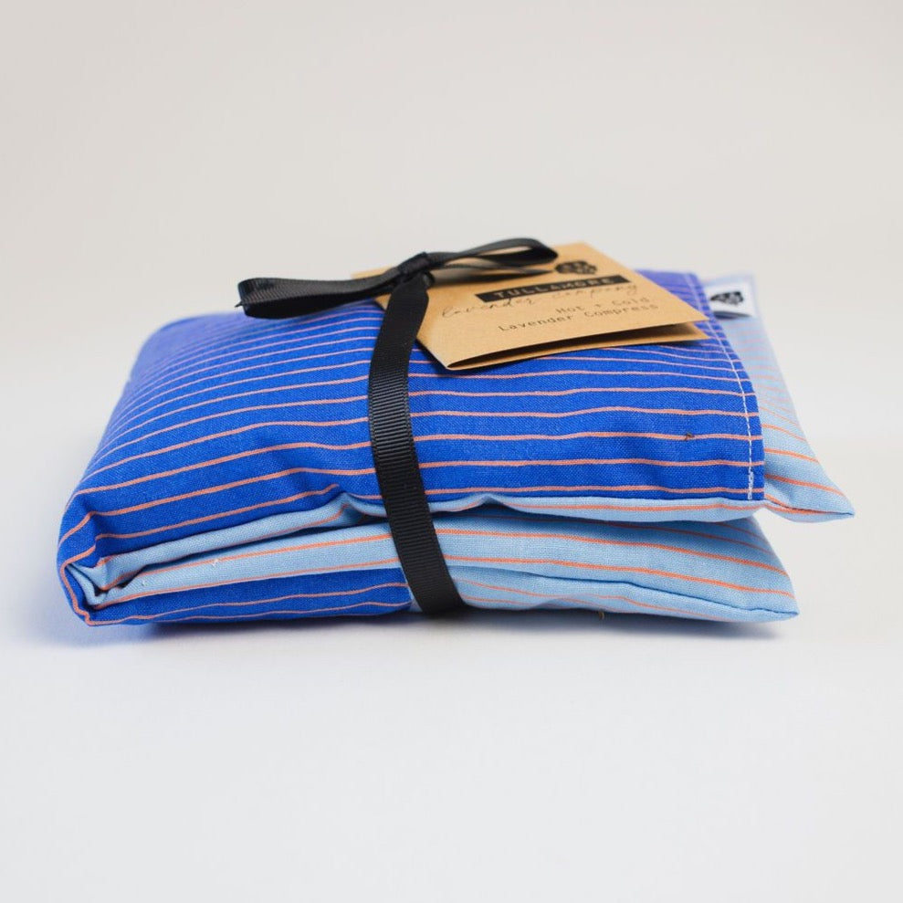 Blue striped compress with black ribbon and brown paper tag
