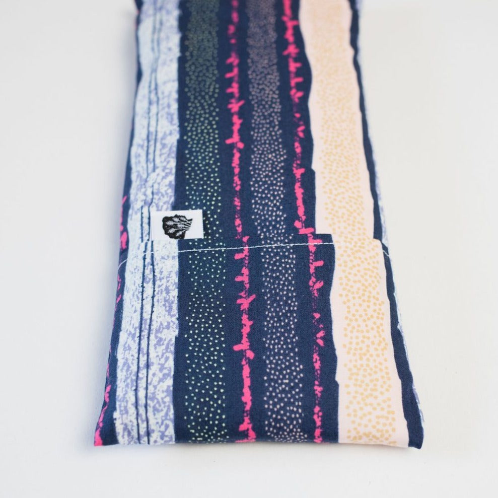 Blue and pink eye pillow on white