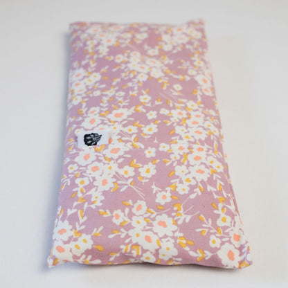 Purple daisy eye pillow on white background