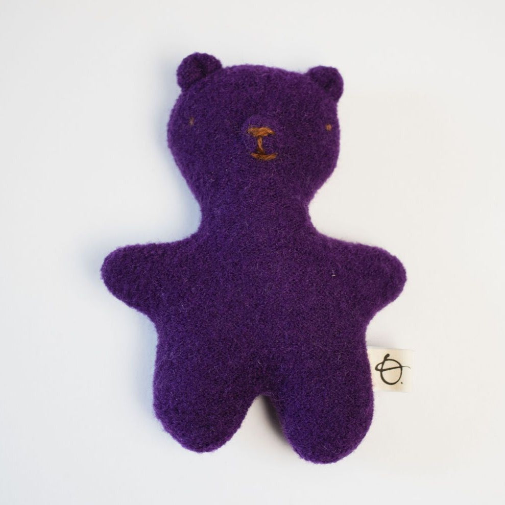 Plum purple teddy bear on white background